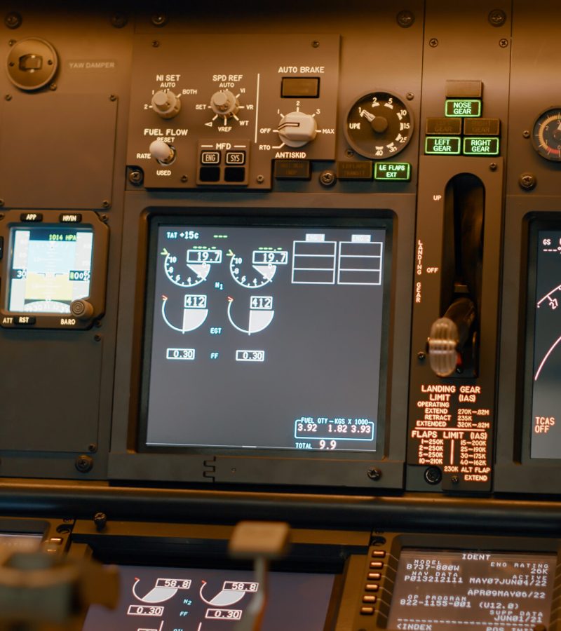 Airplane cockpit with flying command on control panel and dashboard for navigation, engine throttle and radar compass. Plane cabin with windscreen, buttons and handle. Close up.